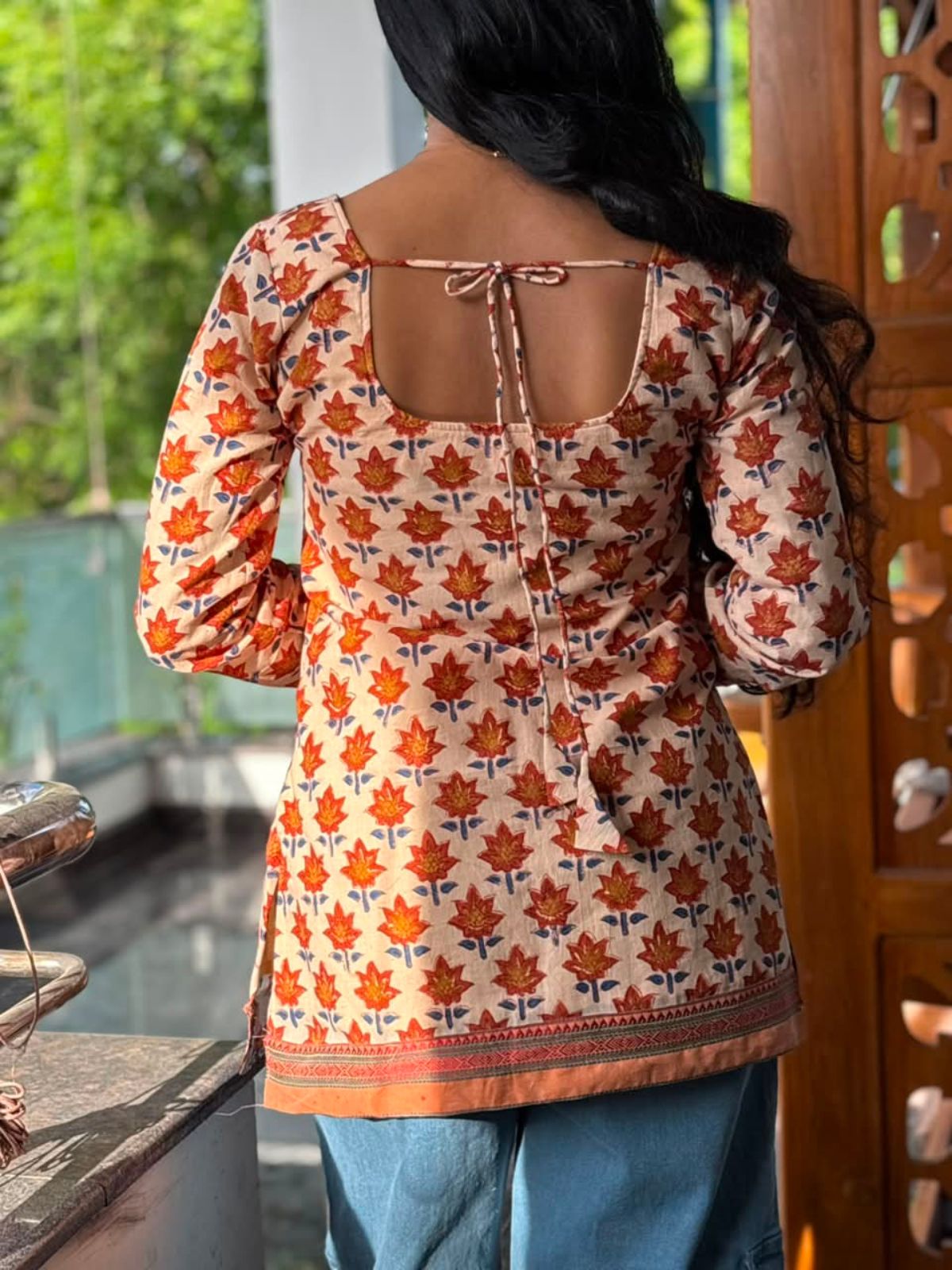 Back view of Rust Orange Floral Motif Cotton Kurti by The Label Razi