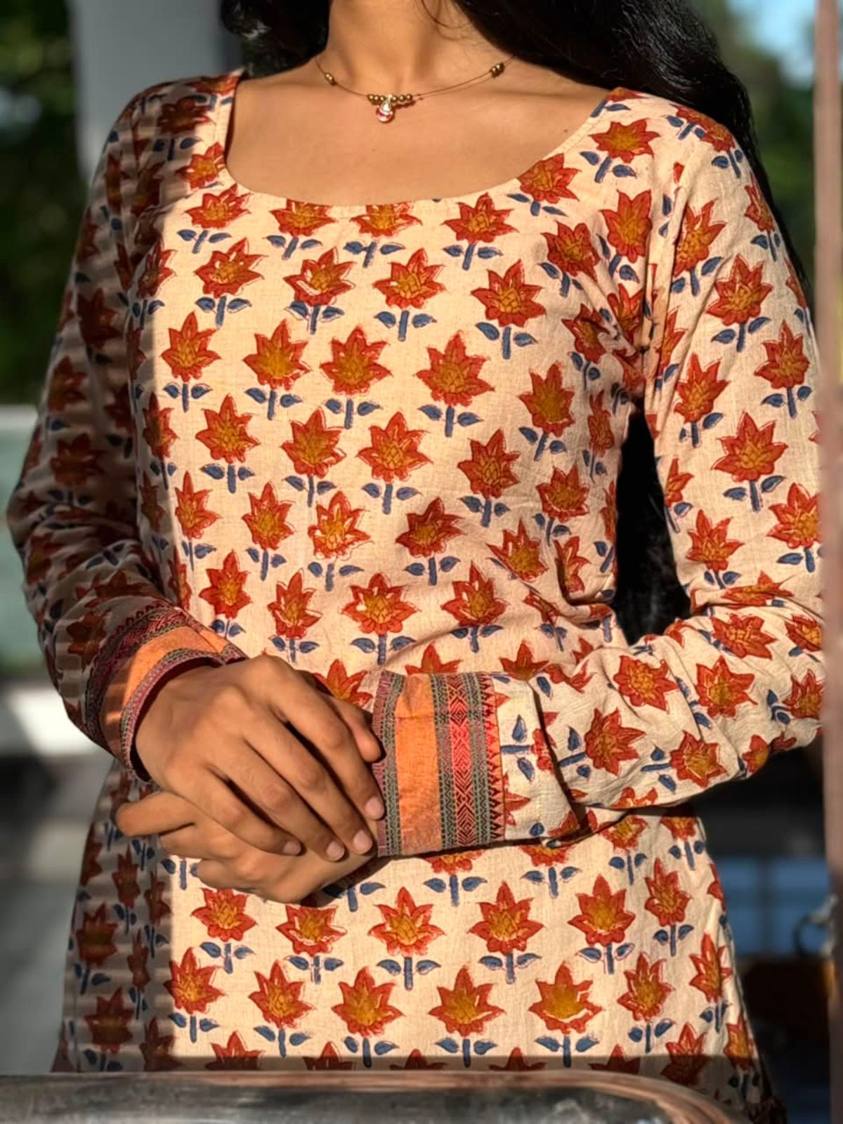 Close-up of the floral motif fabric on the Rust Orange Floral Motif Cotton Kurti by The Label Razi