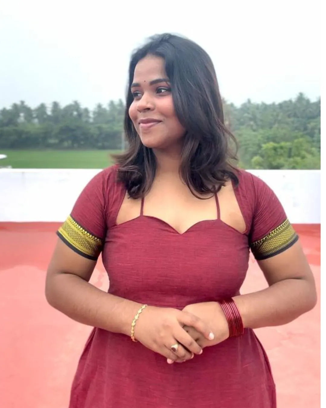 Model wearing a maroon designer dress from The Label Razi