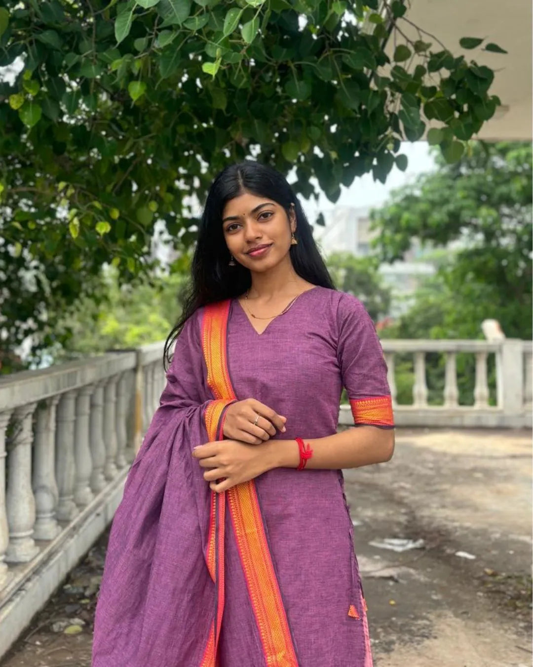 Model wearing a purple cotton kurti with matching dupatta from The Label Razi