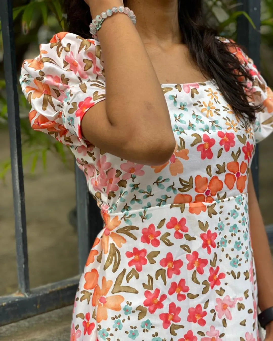 Model wearing a pink floral printed top from The Label Razi