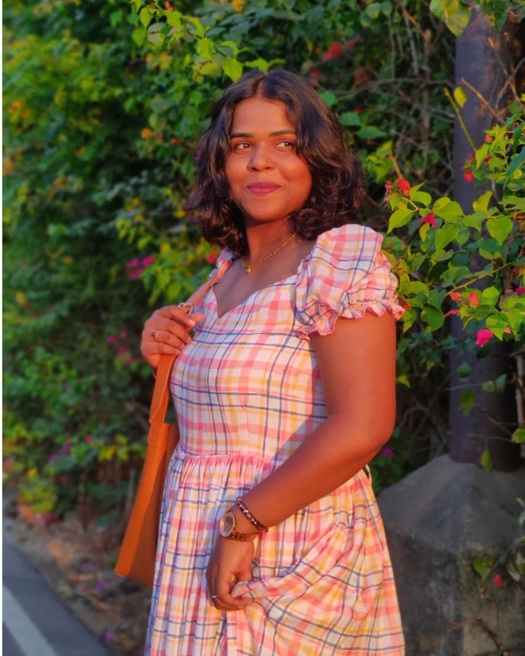 Model wearing a white floral printed dress from The Label Razi